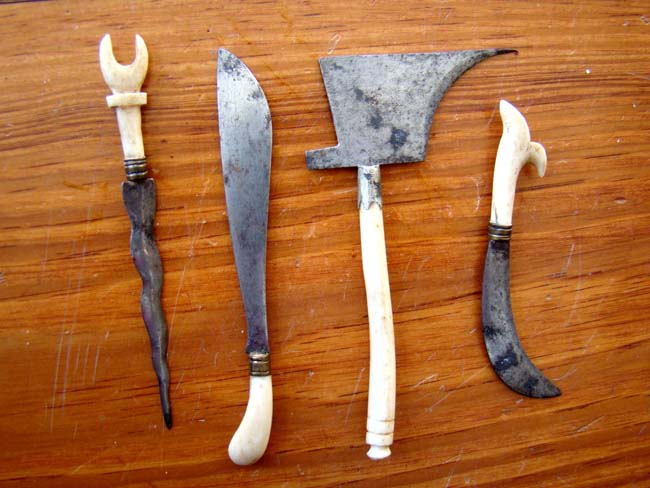 A group of four 19th century miniature steel bladed weapons with bone handles — image 2